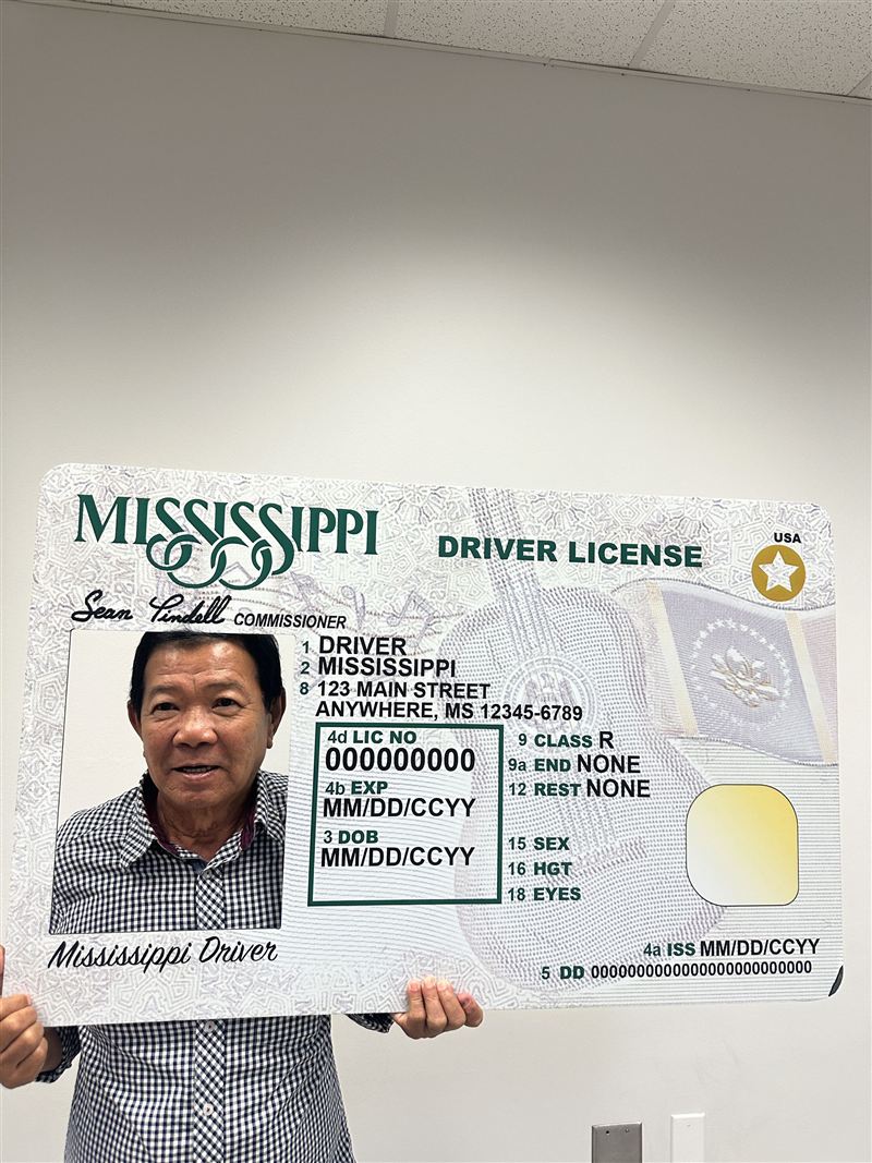 Holding the Mississippi new-driver photo frame at the Department of Public Safety office